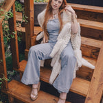  Woman wearing a 70s vintage inspired denim jumpsuit with bell bottom legs handmade in small batches by soul sister since 1969