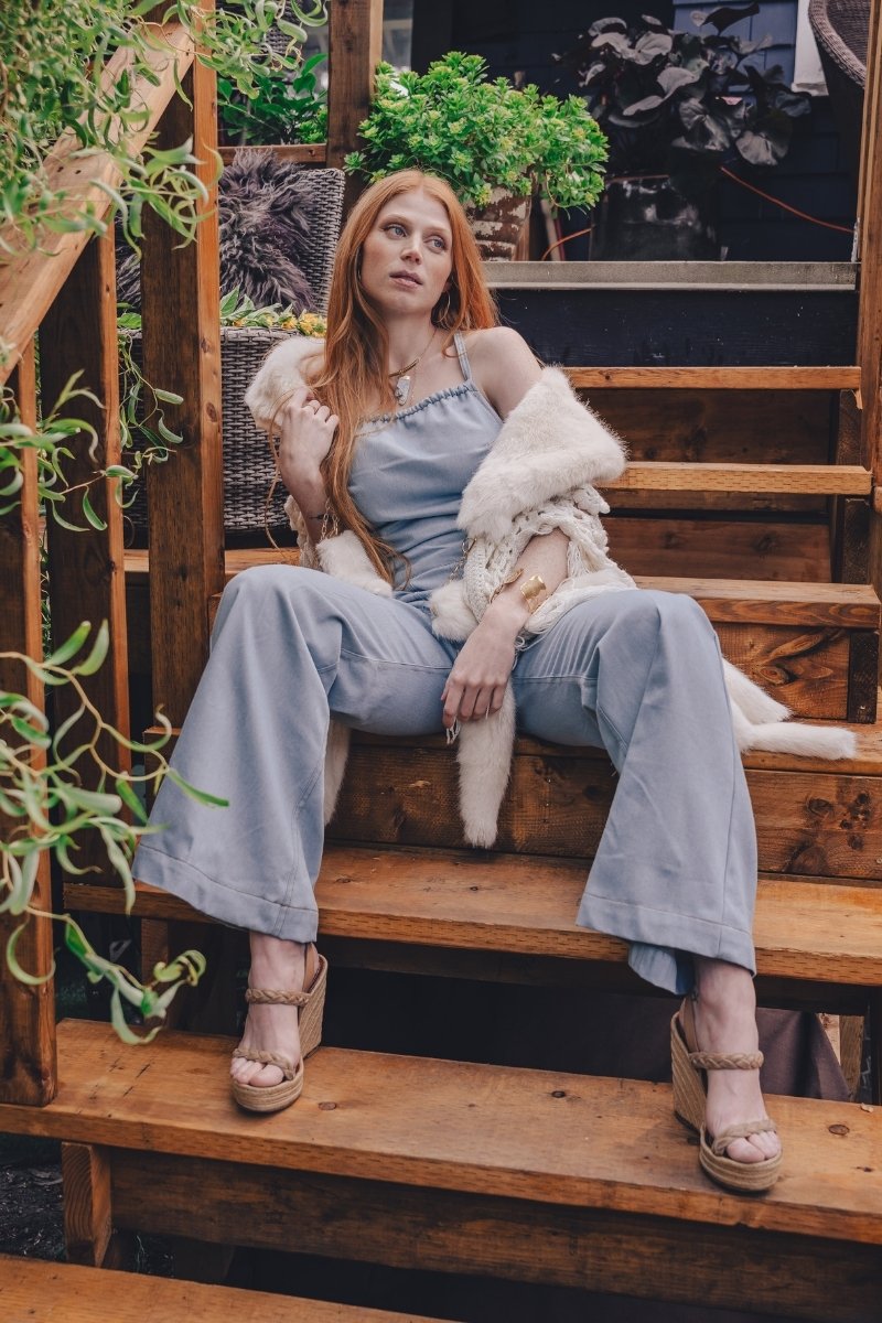  retro 1970s faded denim jumpsuit with a curved hugging fit and wide bellbottoms styled for soul sister since 1969