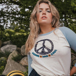 Woman wearing a peace symbol shirt with text outdoors wearing Soul Sister since 1969