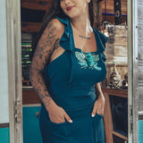 beautiful bohemian embroidered blue dress on woman in a retro trailer