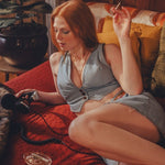 Woman sitting on a couch with a dog, headphones wearing the soul sister since 1969 brand made in Vancouver Canada