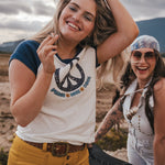 Two women standing outdoors with a scenic background wearing Soul Sister since 1969
