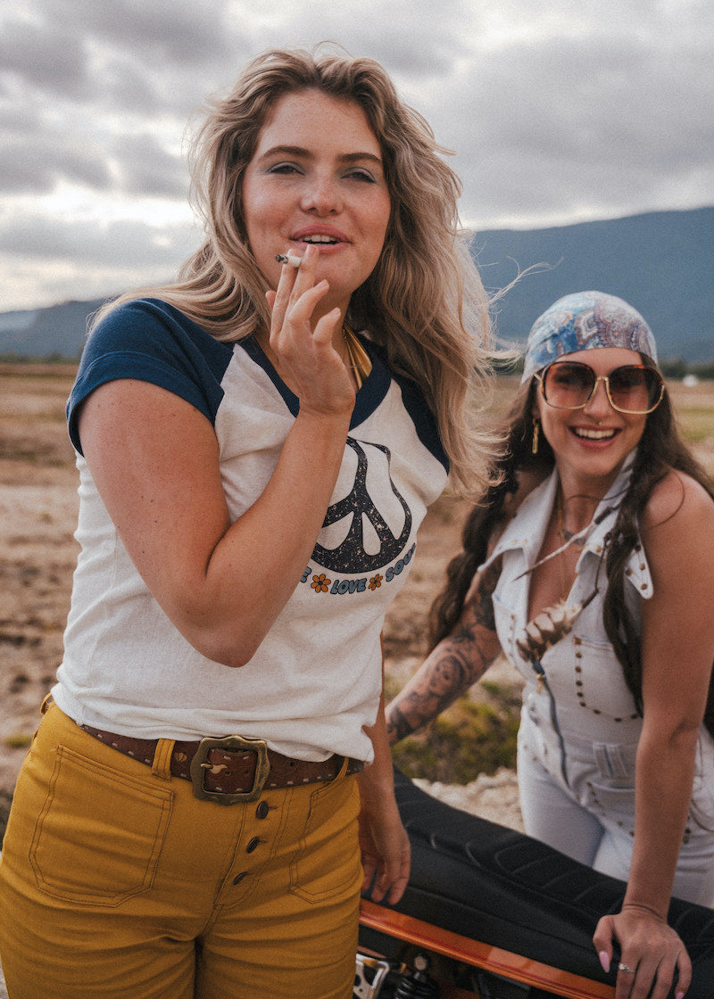 Two women standing outdoors with mountains in the background wearing Soul Sister since 1969