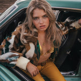 Woman sitting in a vintage car with a scenic background wearing Soul Sister since 1969