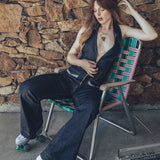 A woman wearing roller skates wears a 70s inspired denim jumpsuit by Soul Sister since 1969