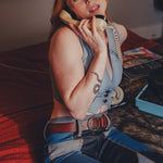 Person in a costume sitting on a couch with a phone to their ear