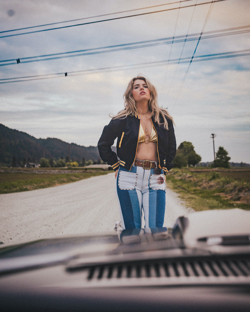 Woman standing on a road with mountains in the background wearing Soul Sister since 1969