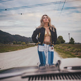 Woman standing on a road with mountains in the background wearing Soul Sister since 1969