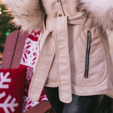 Beige Peny Lane vintage 70s  inspired coat with fur worn by a person, Christmas decorations in the backgrounds