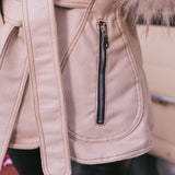Close-up of a beige Penny Lane, 70s vintage inspired coat with fur trim and a zipper detail.