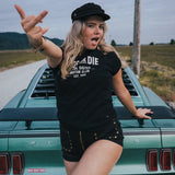 Woman posing in front of a vintage car on a road trip