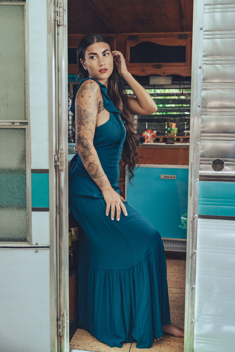 long flowy teal boho maxi dress with open back and ruffle details