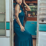 long flowy teal boho maxi dress with open back and ruffle details