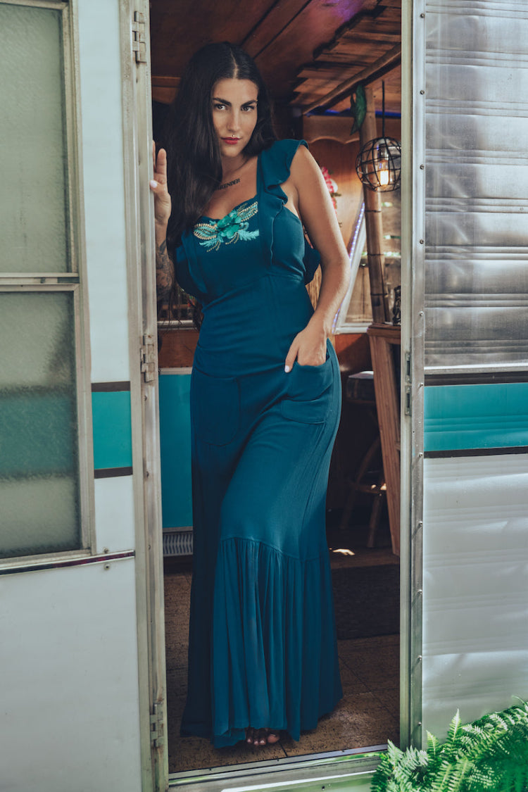 long flowy teal boho maxi dress with open back and ruffle details