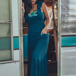 long flowy teal boho maxi dress with open back and ruffle details