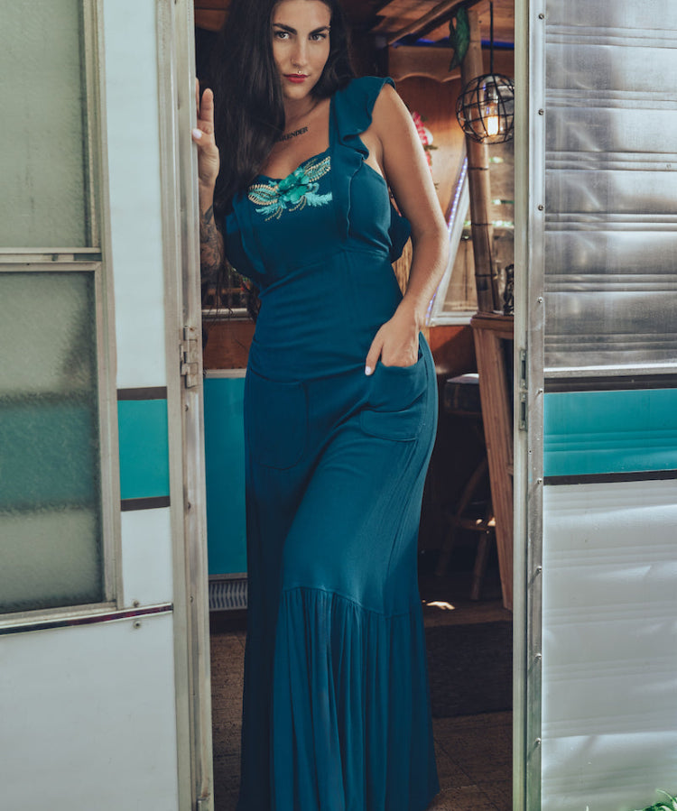 long flowy teal boho maxi dress with open back and ruffle details