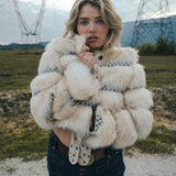 Woman wearing a fluffy white jacket in an outdoor setting with power lines in the background wearing Soul Sister since 1969

