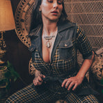 Knit plaid diva jumpsuit with contrasting denim front pockets, collar, and belt, blending retro 70's charm with bold, modern flair.