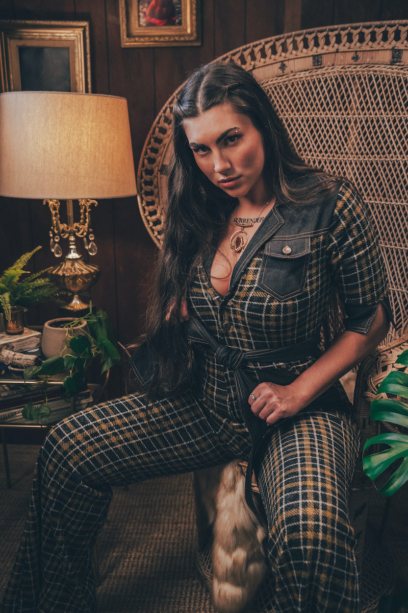 Knit plaid diva jumpsuit with contrasting denim front pockets, collar, and belt, blending retro 70's charm with bold, modern flair.
