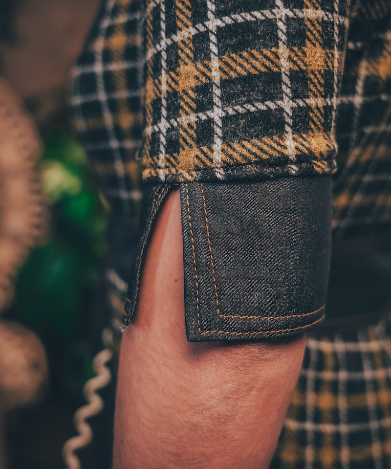 Knit plaid diva jumpsuit with contrasting denim front pockets, collar, and belt, blending retro 70's charm with bold, modern flair.