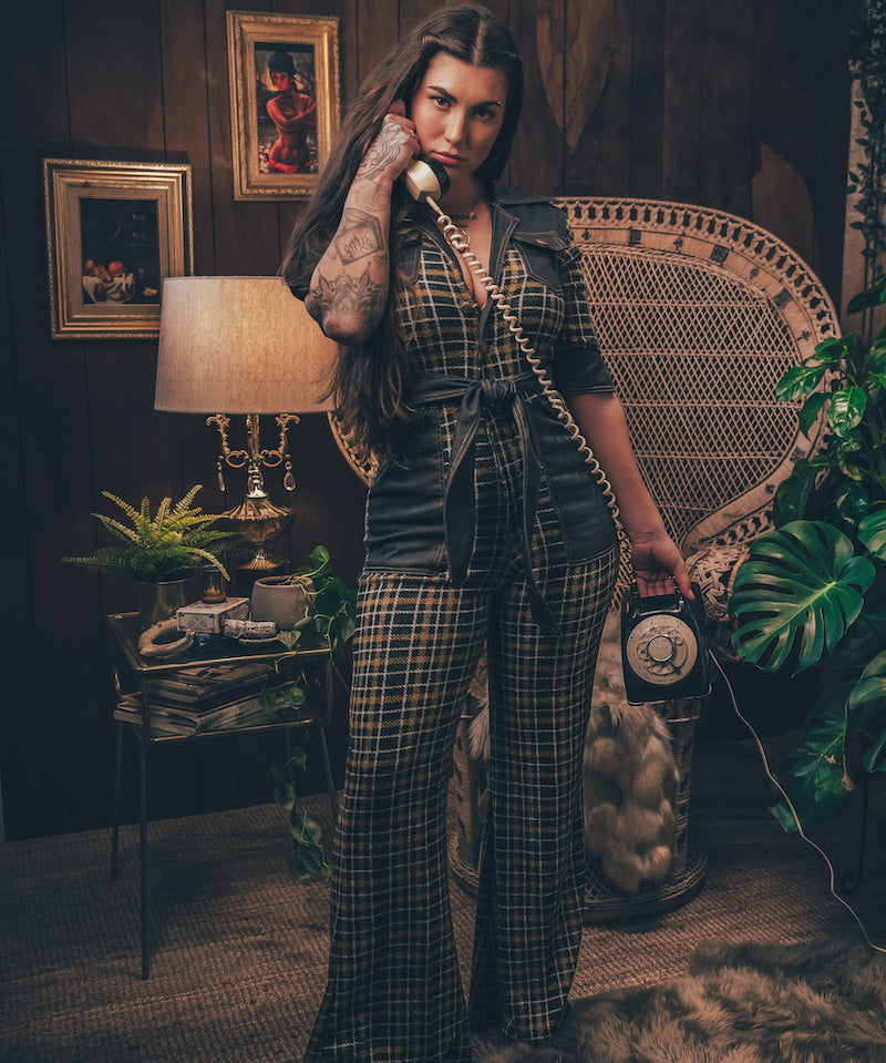 Knit plaid diva jumpsuit with contrasting denim front pockets, collar, and belt, blending retro 70's charm with bold, modern flair.