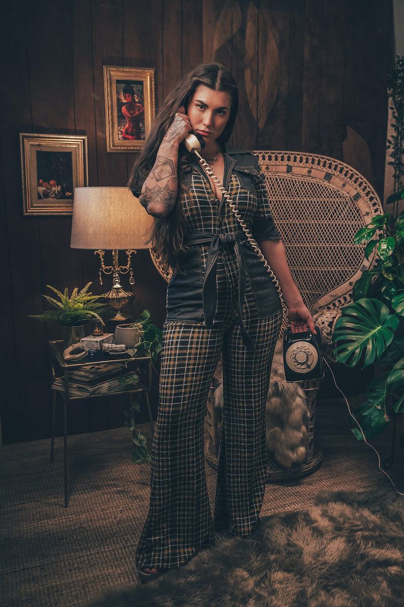 Knit plaid diva jumpsuit with contrasting denim front pockets, collar, and belt, blending retro 70's charm with bold, modern flair.