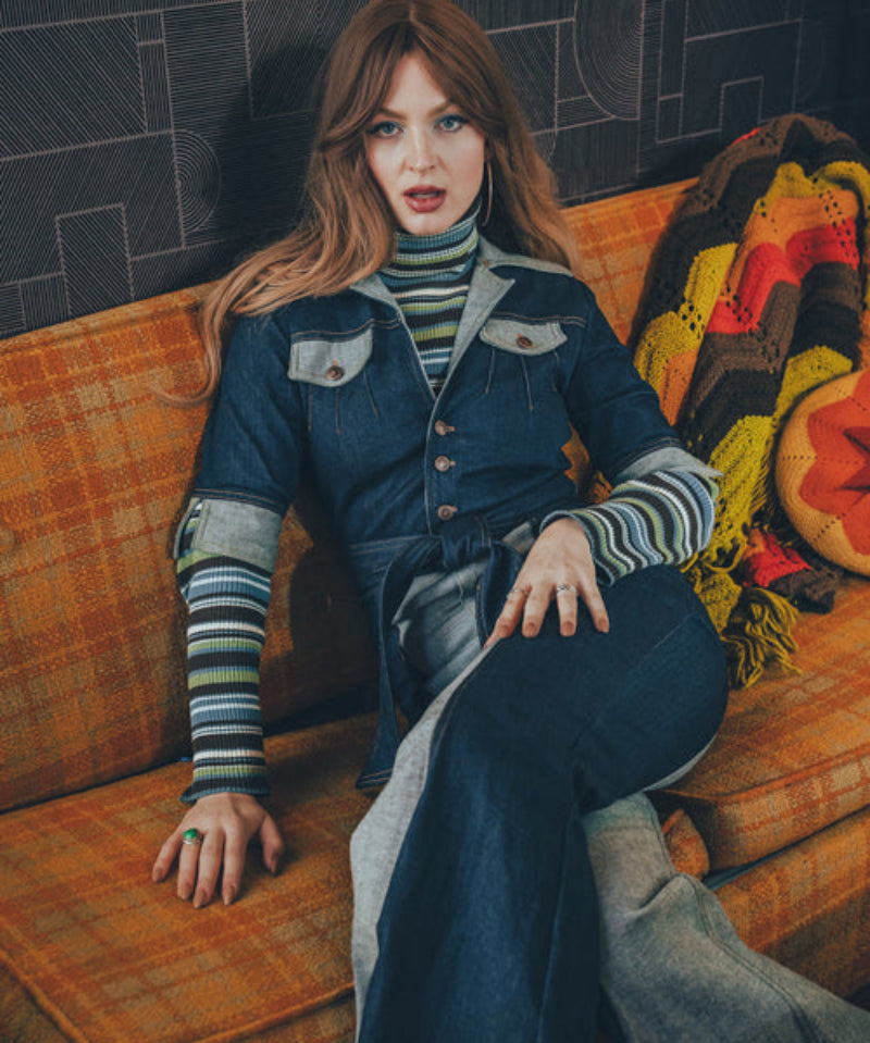 Two-tone women's denim jumpsuit capturing 70s style with contrast panels and a curve flattering fit