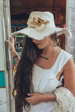 Beautiful woman wears a big denim hat in white 
