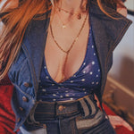 Person wearing a blue denim outfit with a star-patterned top.