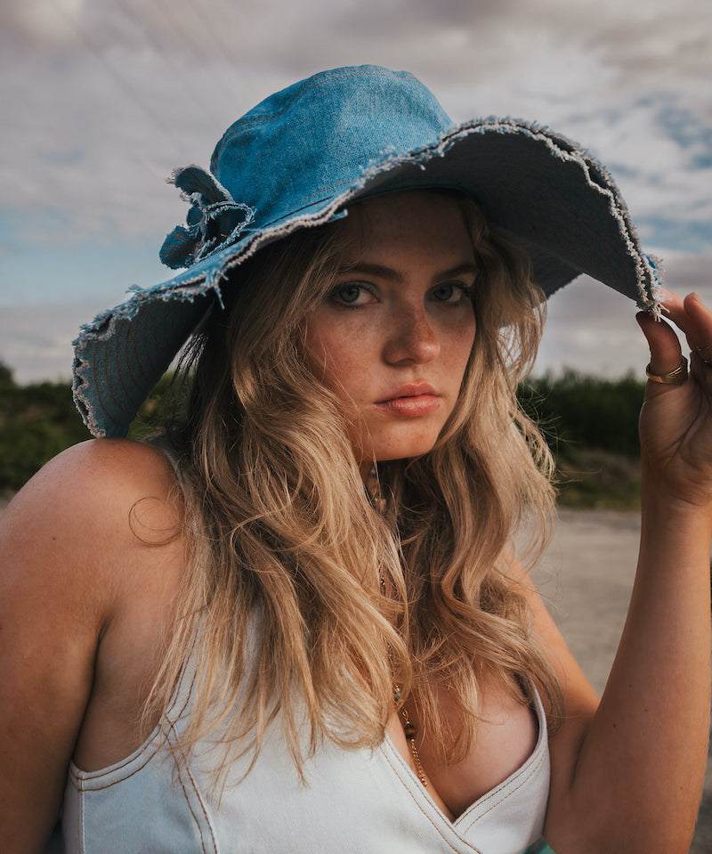 Woman wearing a blue denim hat outdoors with a natural background Wearing Soul Sister since 1969