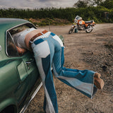 Person leaning out of a car window with a motorcycle in the background wearing Soul Sister since 1969.