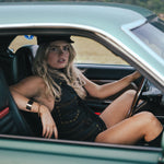 Woman sitting in a car with scenic background wearing Soul Sister since 1969