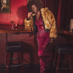 Our Soul Sister muse wears an iconic 1970s inspired faux fur bomber style coat worthy of studio '54 disco parties.