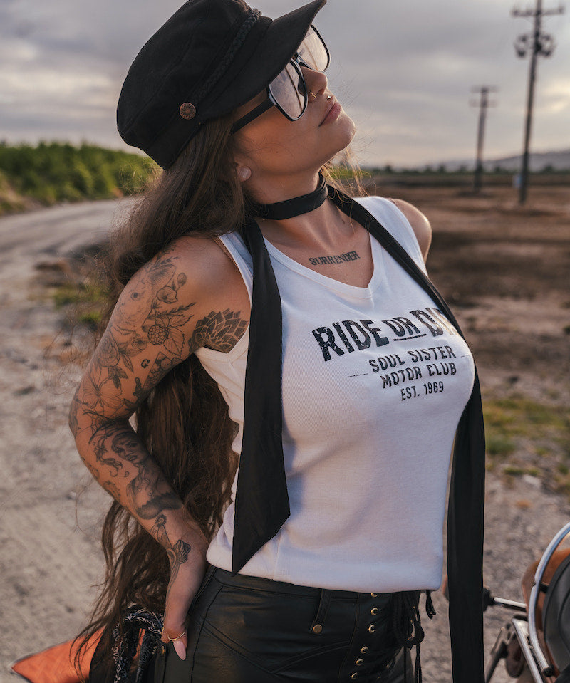Woman wearing a 'Ride or Die' tank top in an outdoor setting wearing soul sister since 1969