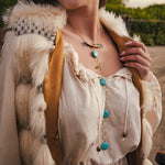 Person wearing a fur vest and white blouse with accessories outdoors wearing soul sister since 1969